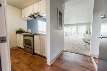 The view of a kitchen and living room from the doorway